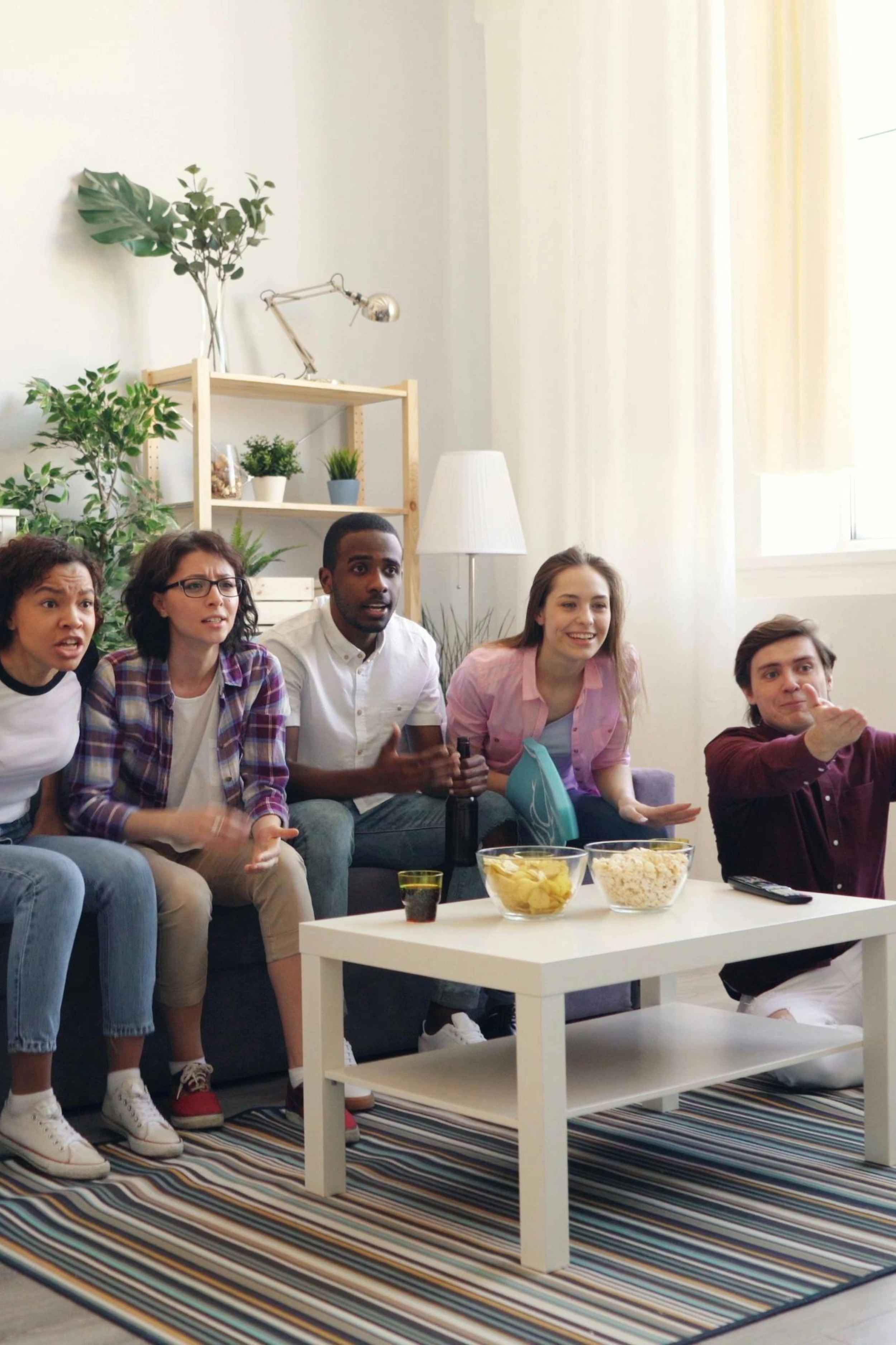 Happy family enjoying cable TV together at home